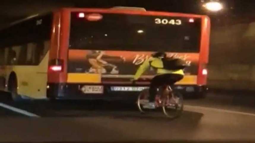 Imagen del temerario ciclista a rebufo del autobús